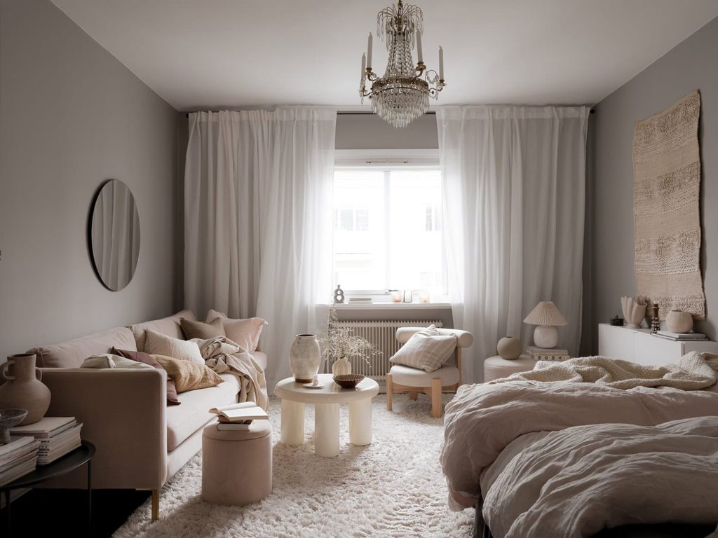 A studio flat with grey walls and a soft decor palette