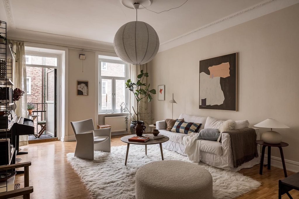 A cozy apartment with kitchen cabinets painted in olive green