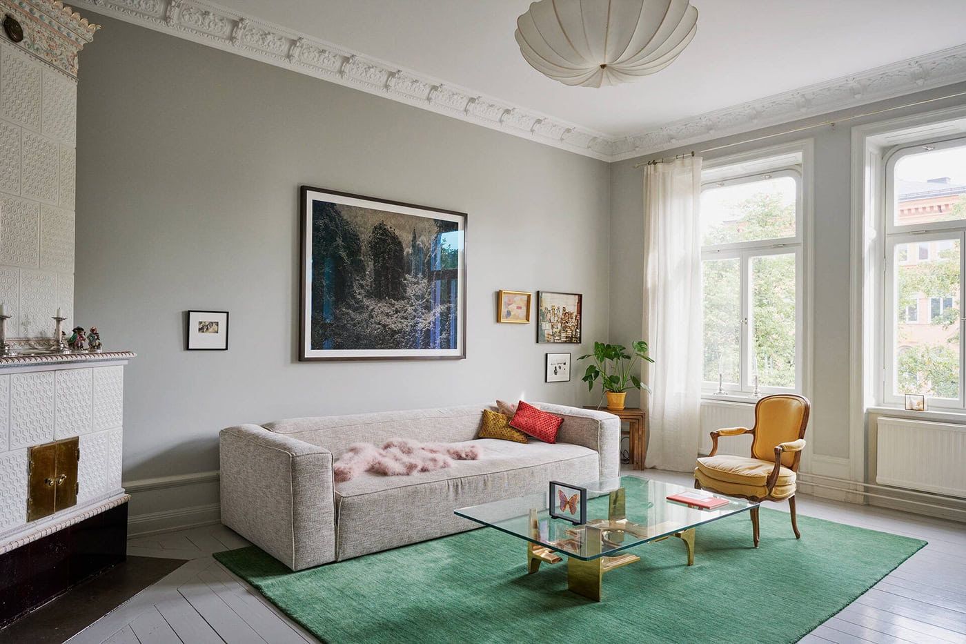 Pops of color in a modern eclectic interior with grey hardwood floors
