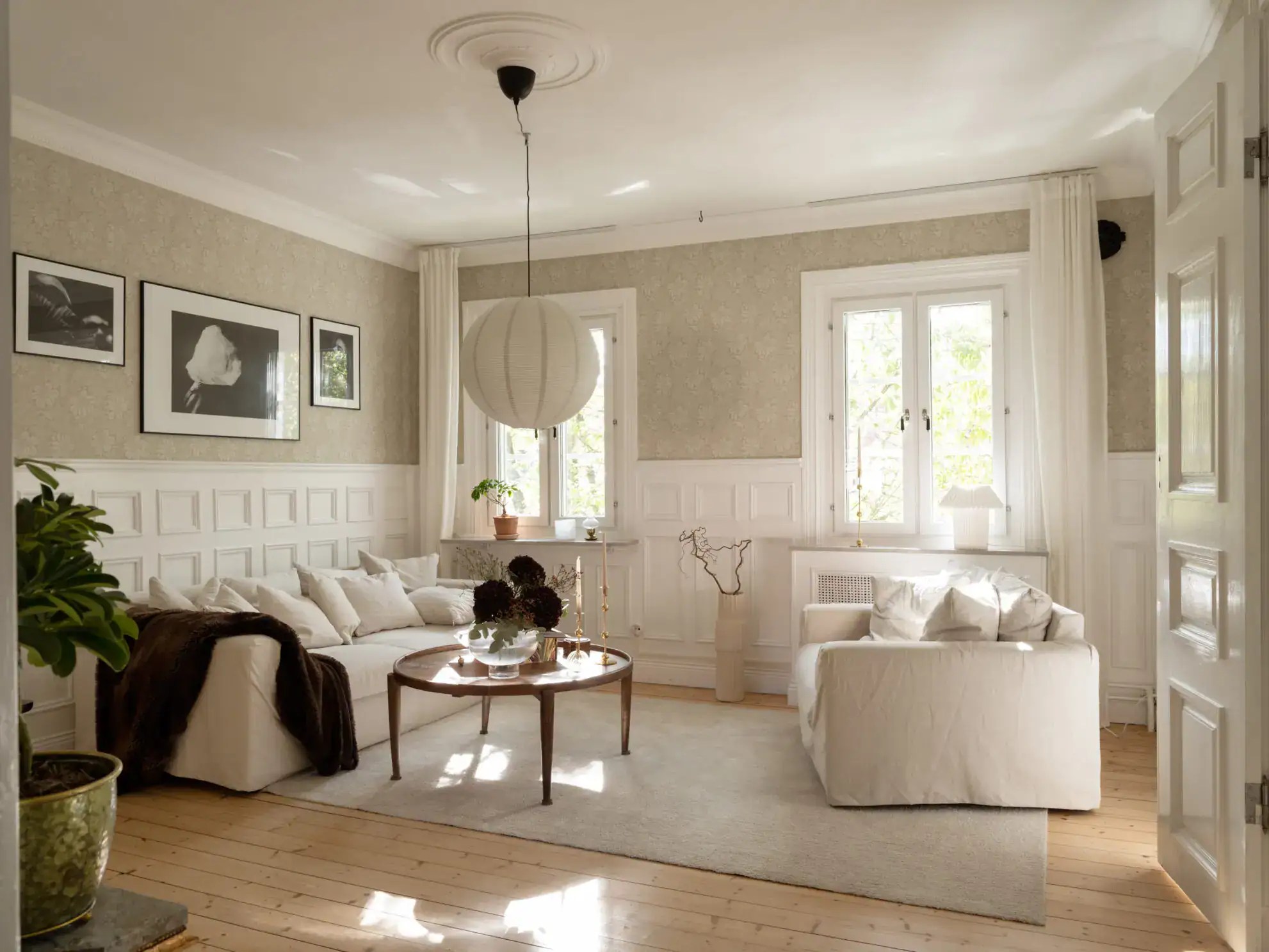Intricate wainscoting in a historic home with a sage green bedroom